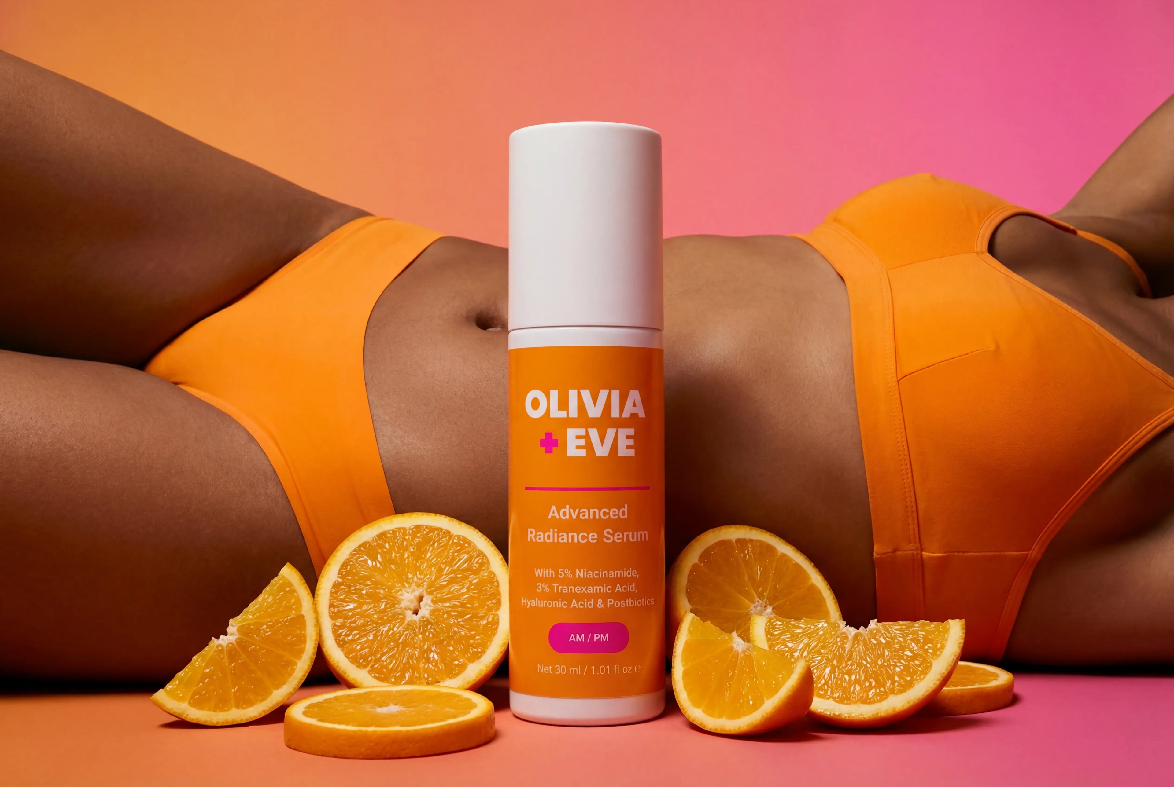 Olivia + Eve serum bottle with oranges on a gradient background
