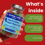 A hand holds a jar of Olivia + Eve Apple Cider Vinegar Chewable Gummies against a bright red background with white and green text callouts describing the ingredients and benefits.