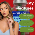 A woman holds a green gummy near a large jar of OLIVIA + EYE Apple Cider Vinegar Gummies against a red background, with green callout bubbles highlighting key features: suitable for vegans and vegetarians, no artificial colours, and non-GMO.