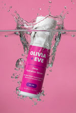 Olivia + Eve Deep Hydration Serum bottle with water splash on a pink background