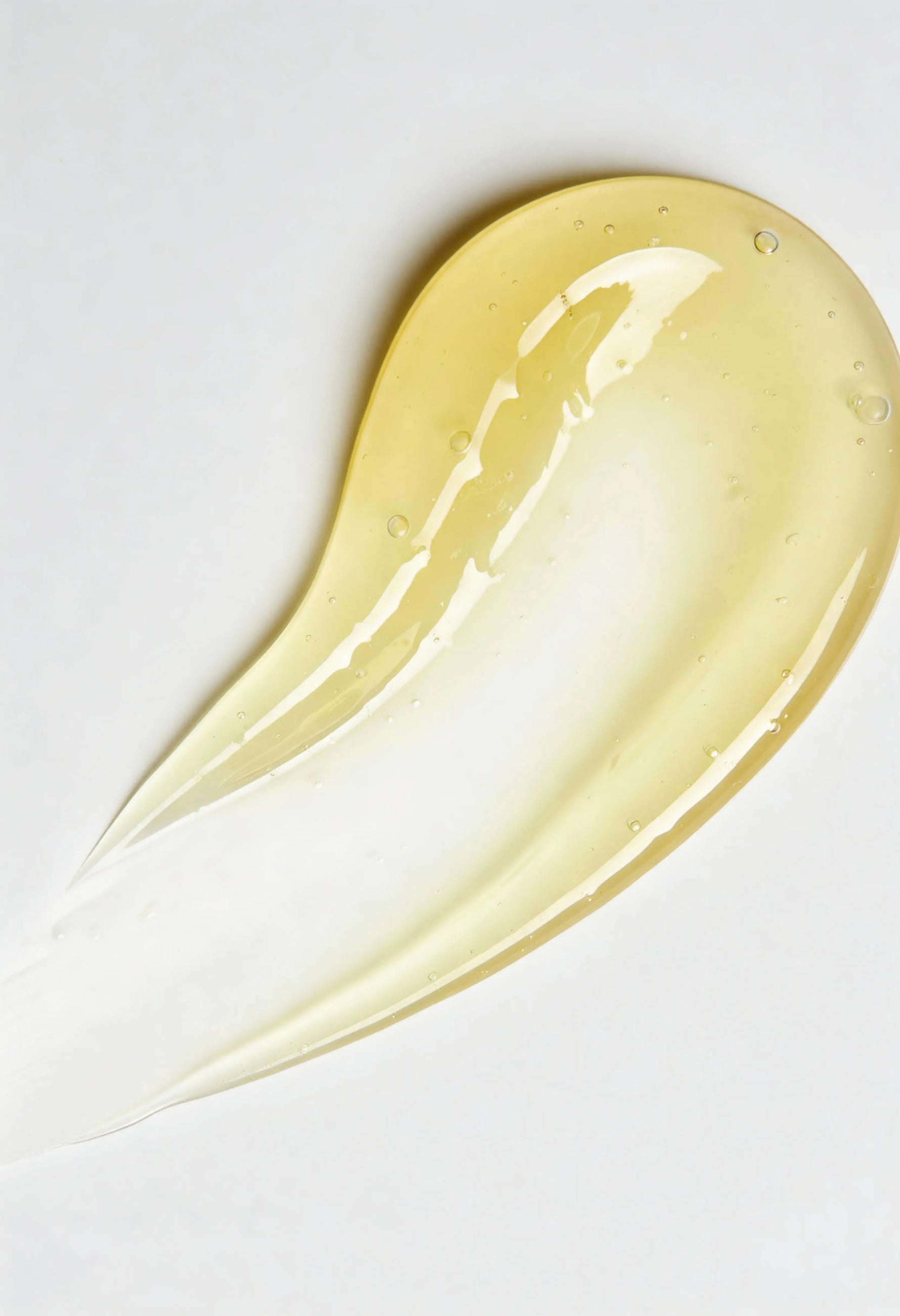 Yellow serum smear on a white background