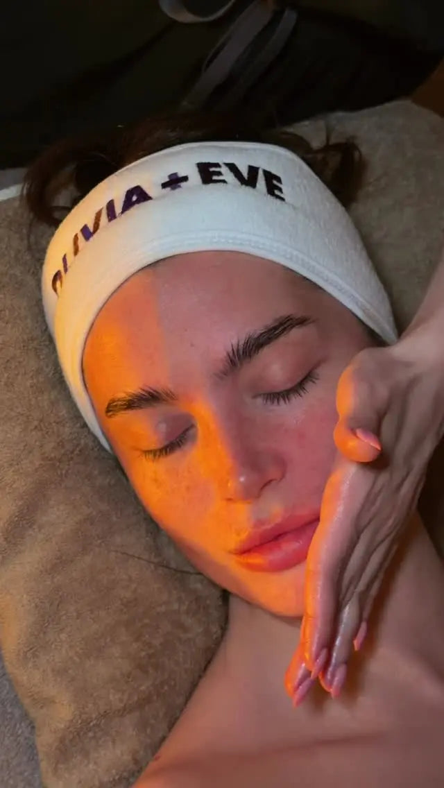 Woman getting a face massage with Olivia + Eve products