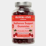 A clear plastic bottle of Olivia + Eve Radiance Support Gummies with a silver cap and a pink label featuring cherry illustrations, set against a light gray background.