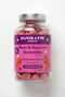 Jar of pink gummies labeled 'Olivia + Eve London Rest & Recover Gummies' on a white background