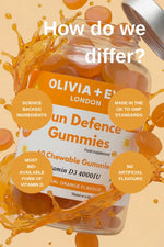Olivia + Eve Sun Defence Gummies packaging with orange liquid splash on a beige background