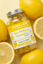 Jar of Olivia + Eve Sun Defence Gummies surrounded by lemons on a yellow background