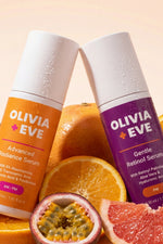 Two bottles of Olivia Eve serum with fruits on a peach background