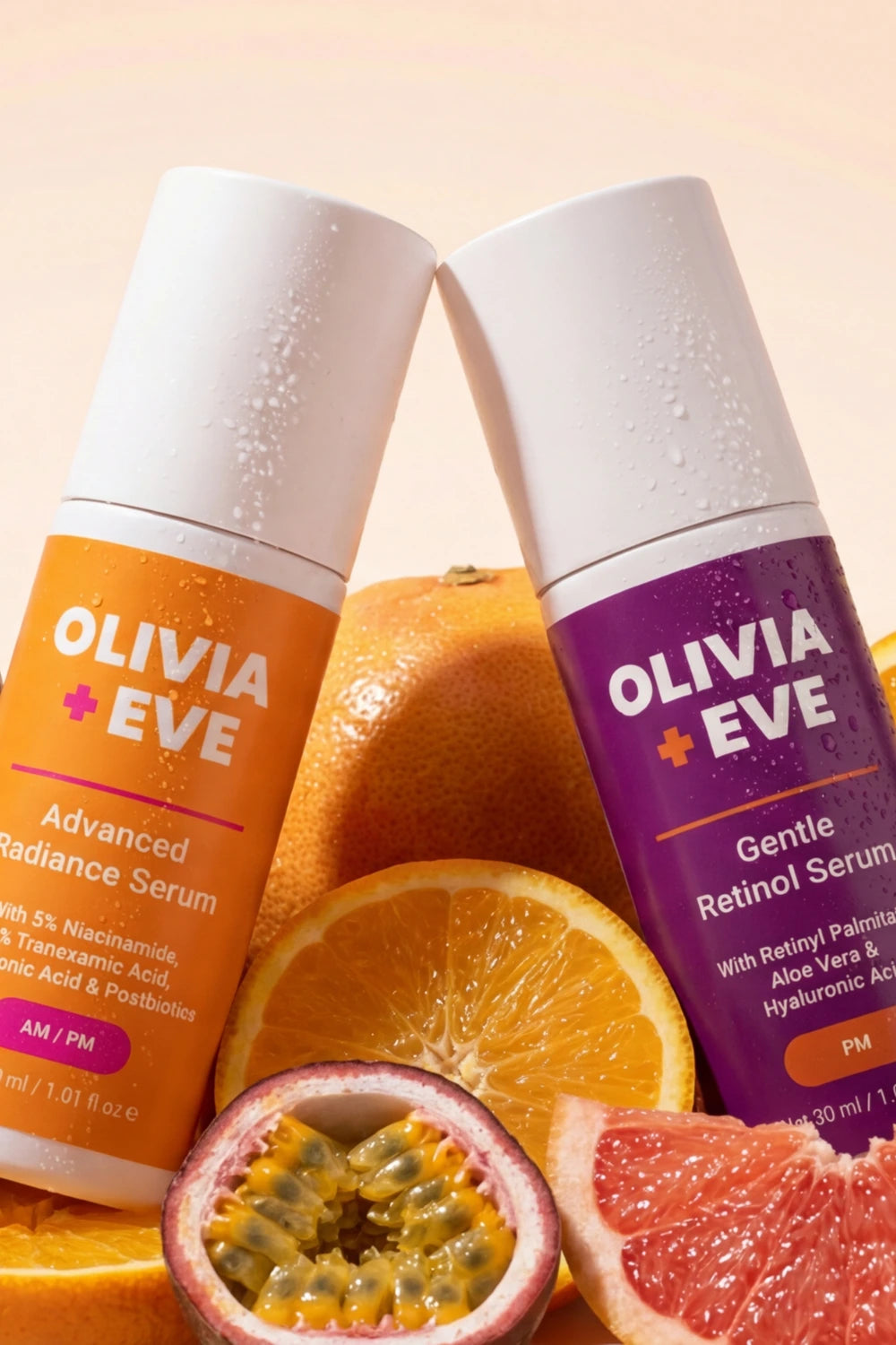 Two bottles of Olivia Eve serum with fruits on a peach background