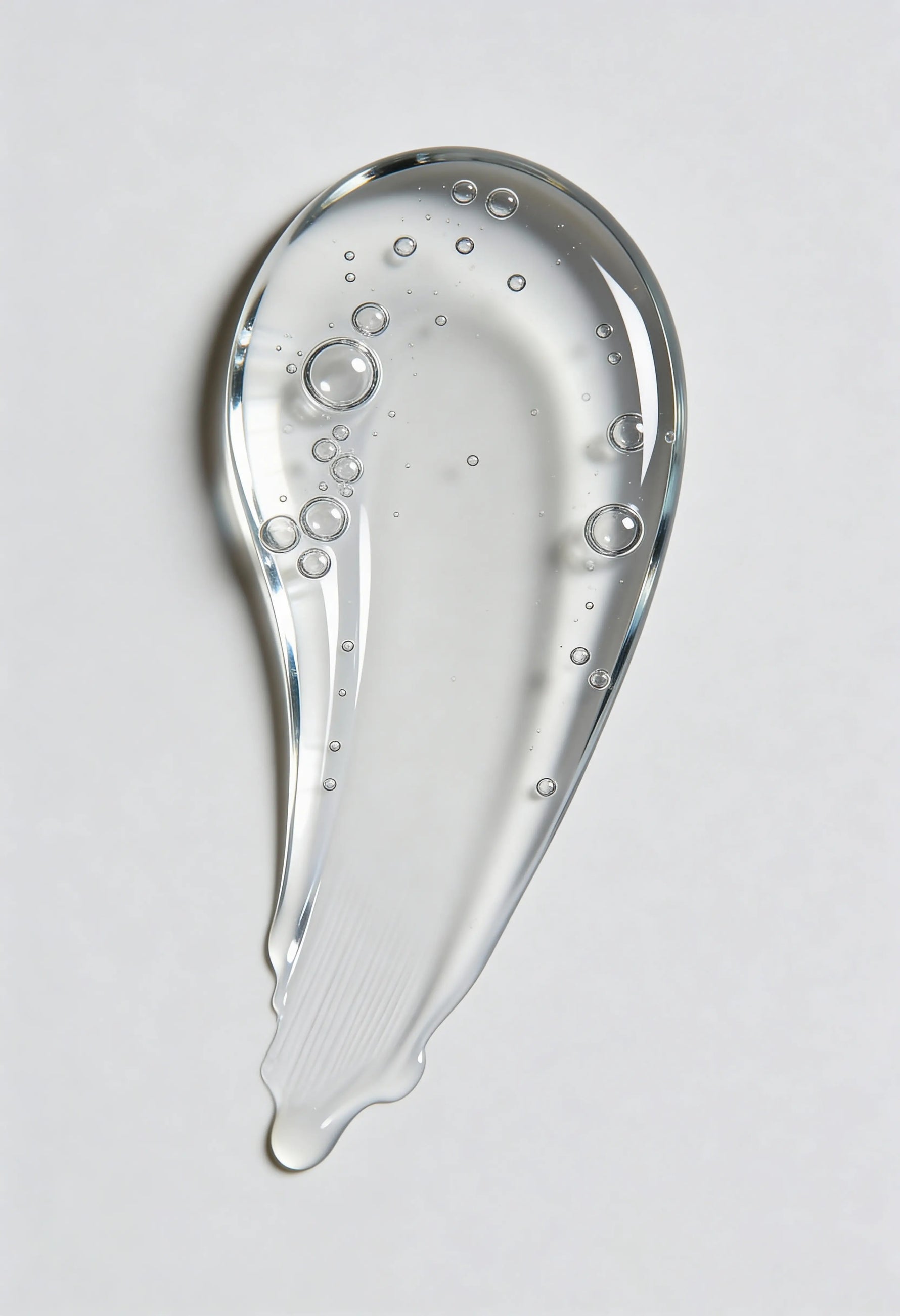 Clear gel or serum with bubbles on a light gray background